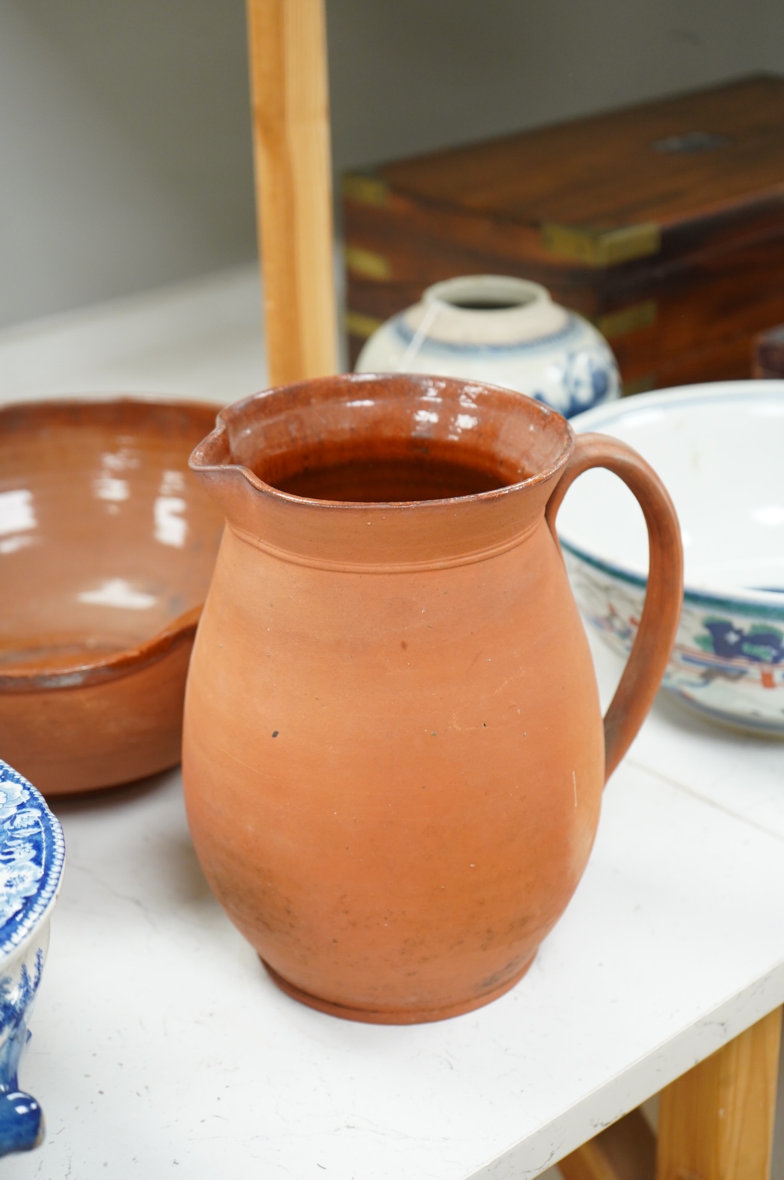An early 19th century pearlware tureen, a pair of pearlware leaf dishes, a glazed earthenware jug and basin